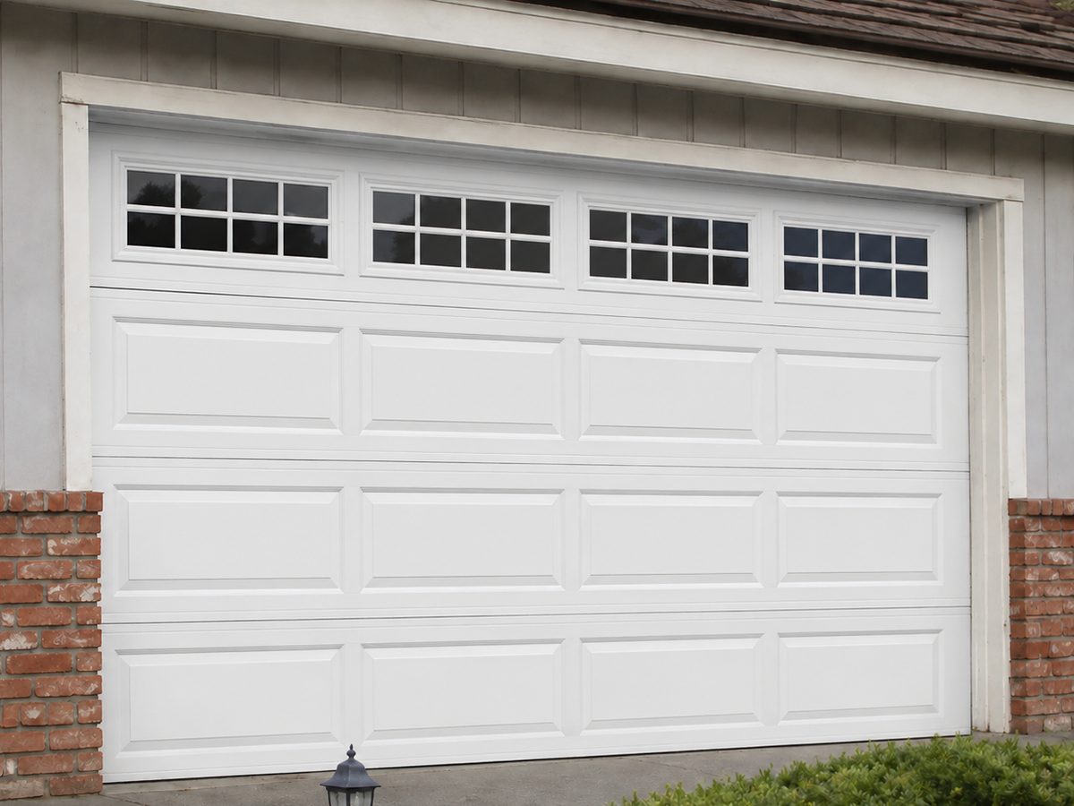 New white garage door with window row after replacement